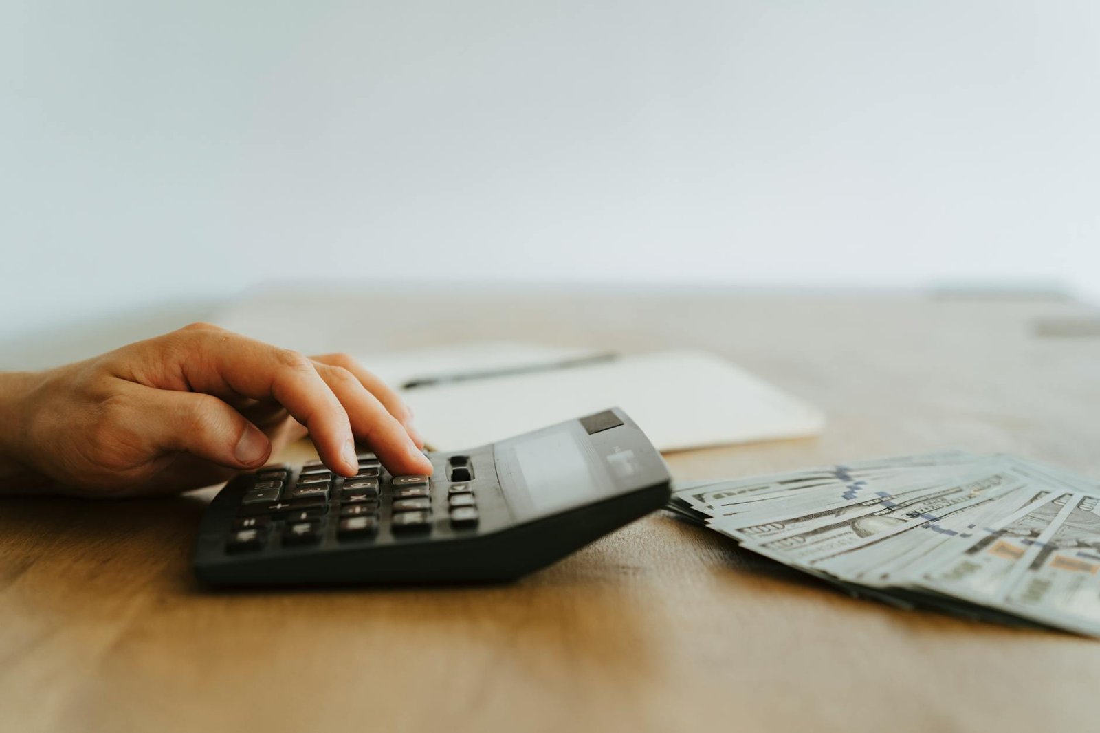 Notebook with debt payoff calculations and bills on desk